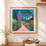 Finished colorful garden path landscape cross stitch artwork displayed as home decor