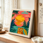 Colorful jungle sunset with owl punch needle artwork displayed on a table