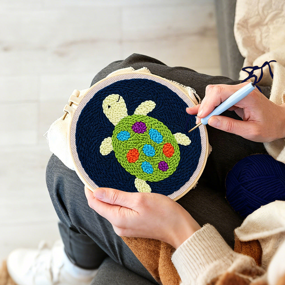 Creating handmade colorful little turtle punch needle artwork