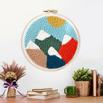 Finished colorful mountain landscape artwork displayed on a wall