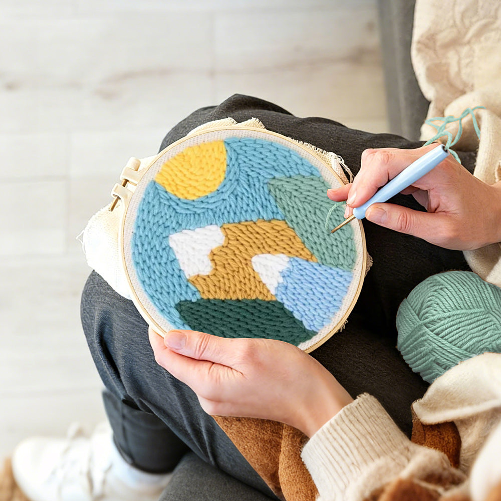 Creating handmade colorful mountain landscape with sun punch needle artwork