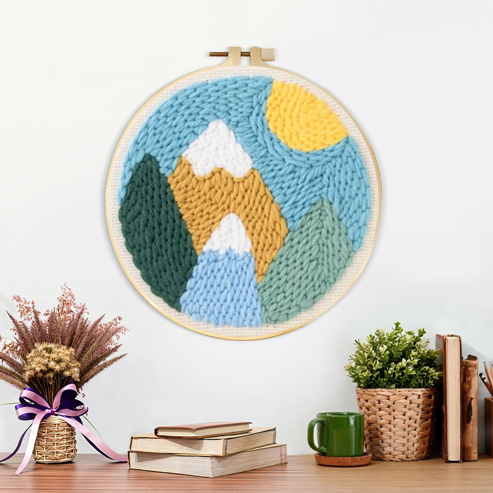 Finished colorful mountain landscape with sun artwork displayed on a wall
