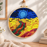 Colorful mountain sunset embroidery hoop wall art displayed as warm and cozy handmade home decor