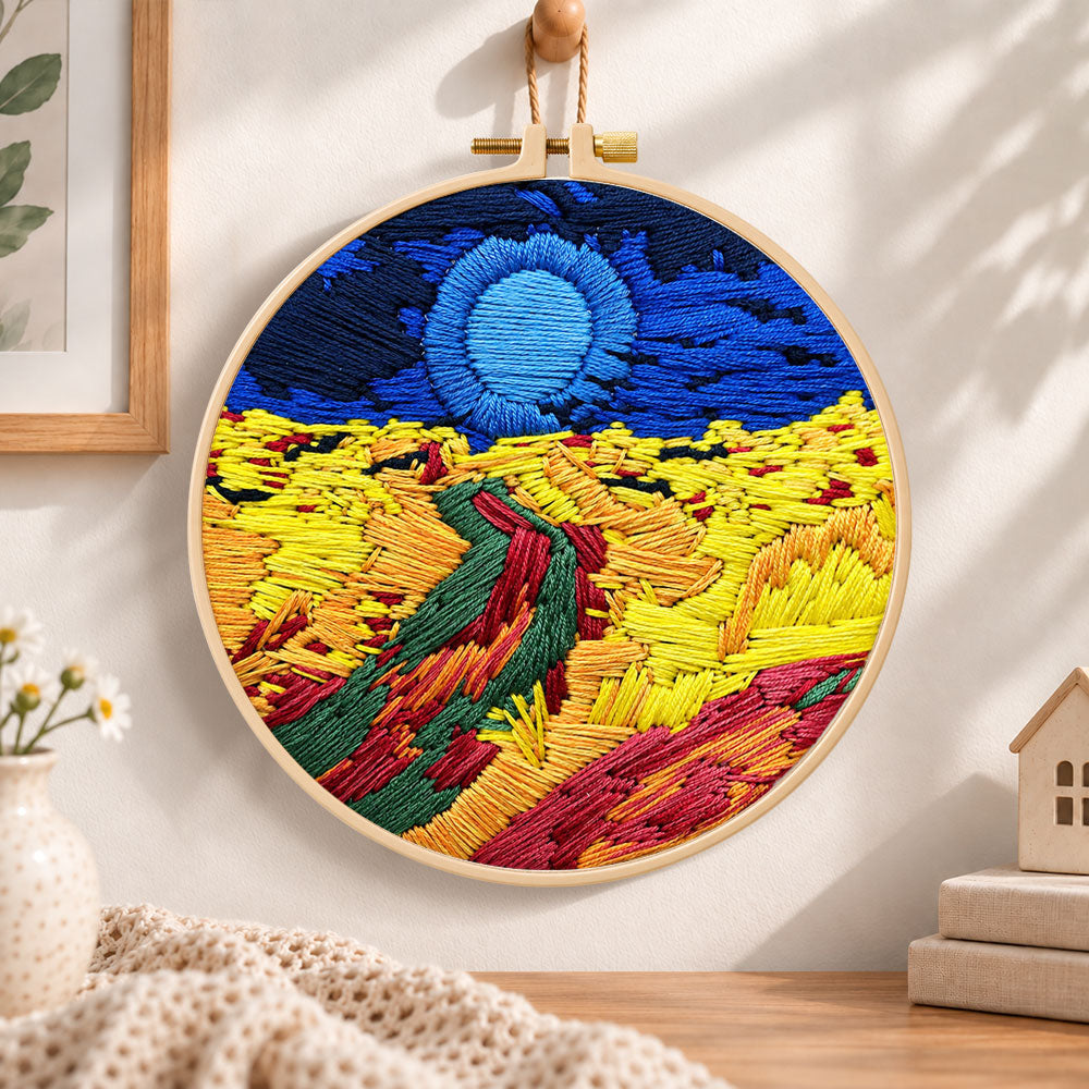 Colorful mountain sunset embroidery hoop wall art displayed as warm and cozy handmade home decor
