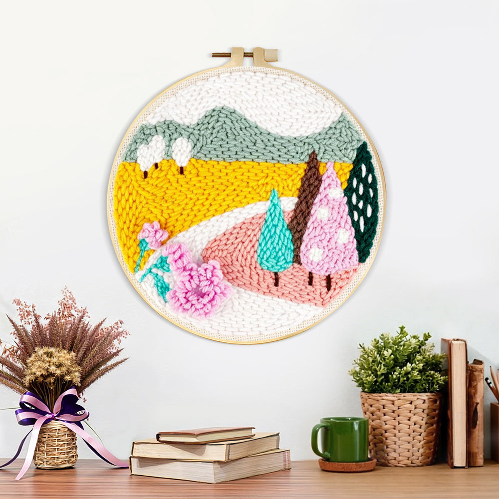 Finished colorful mountains and trees artwork displayed on a wall