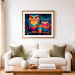 Finished colorful owl family on branch cross stitch artwork displayed as home decor