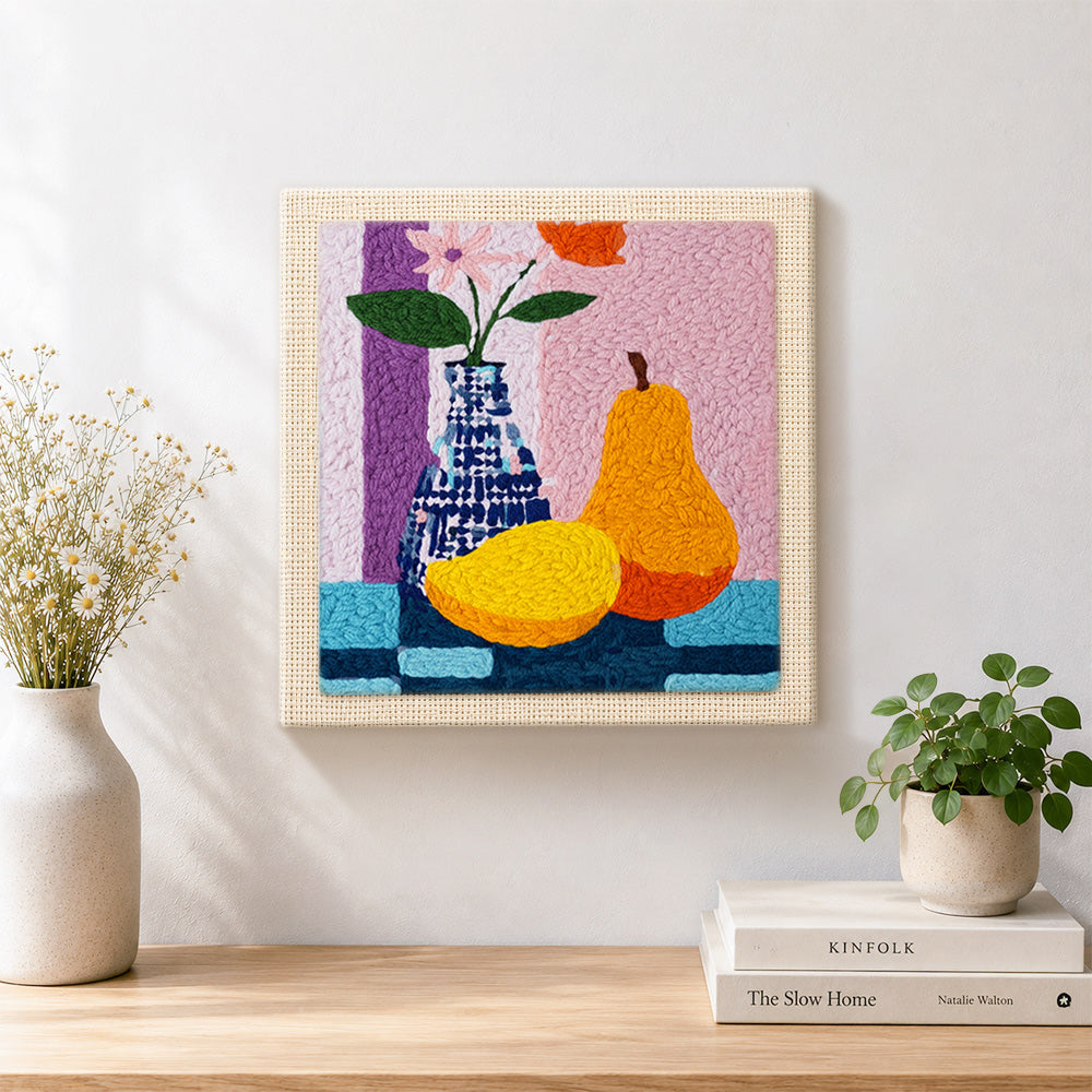 Finished colorful pear and vase still life artwork displayed on a wall
