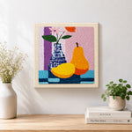 Finished colorful pear and vase still life artwork displayed on a wall