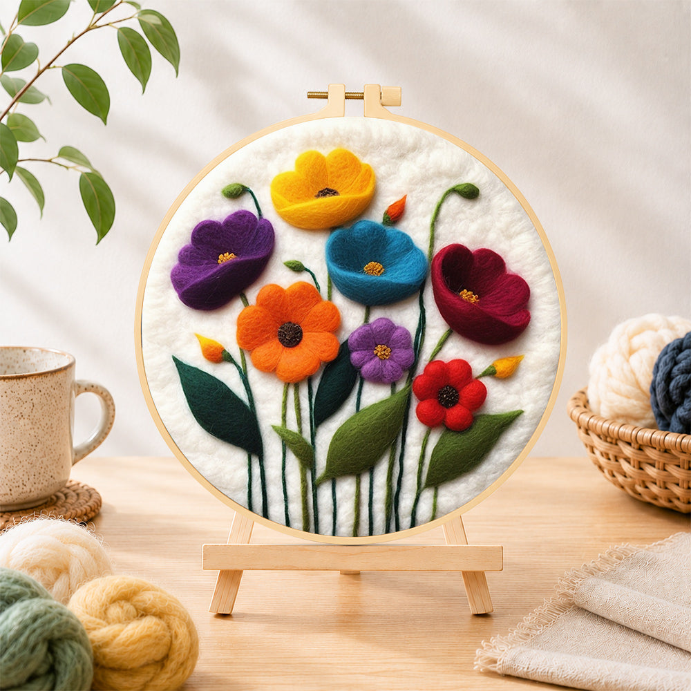 Finished colorful poppies needle felting displayed on a wooden easel