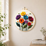 Colorful poppies needle felt wall art displayed in a bright home interior