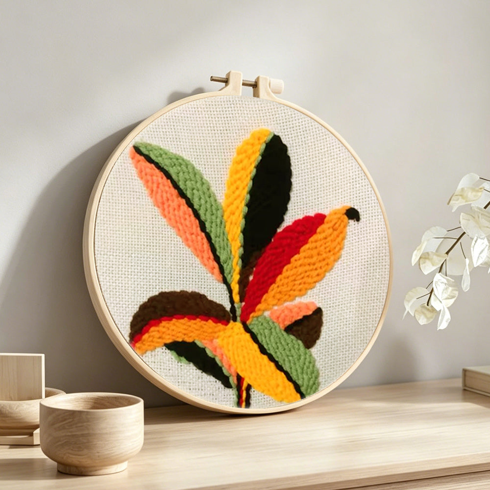 Colorful radial leaves punch needle artwork displayed on a table
