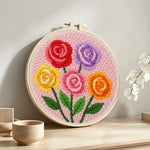 Colorful rose bouquet punch needle artwork displayed on a table