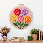 Finished colorful rose bouquet artwork displayed on a wall