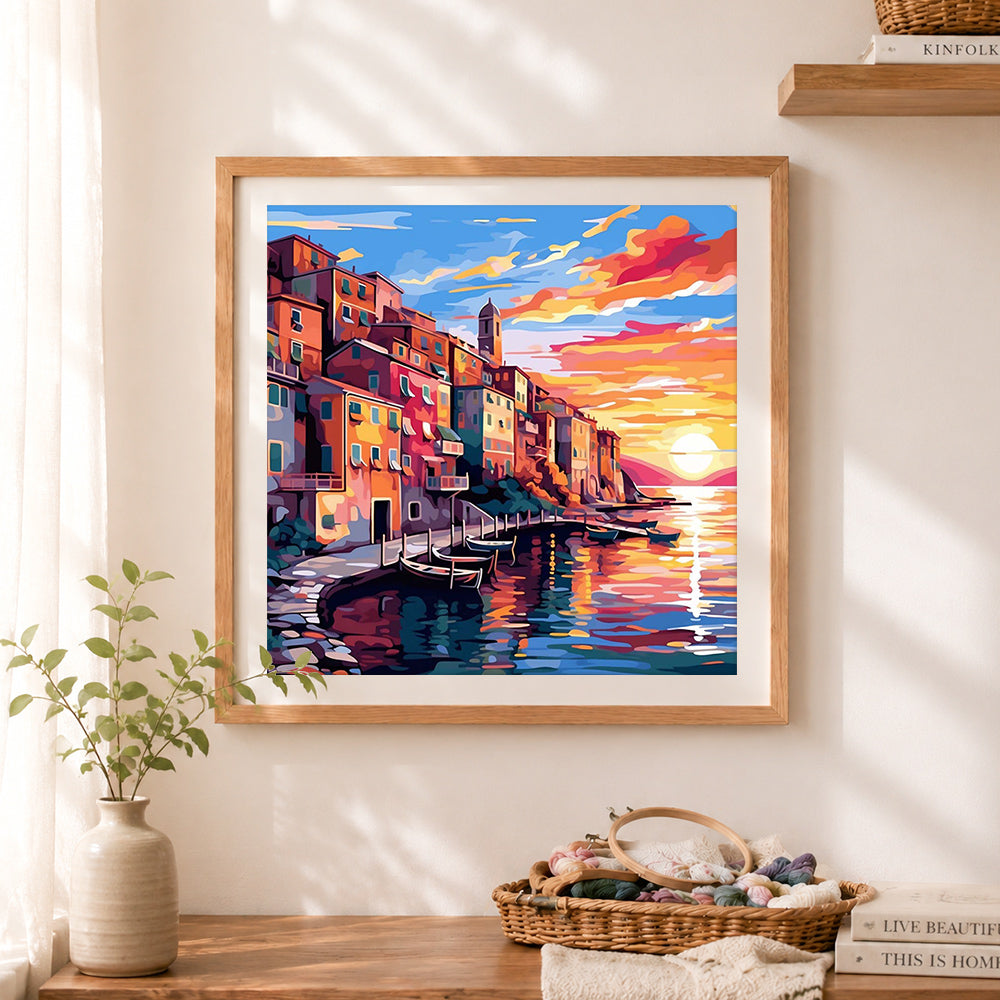 Finished colorful seaside harbor cross stitch artwork displayed as home decor