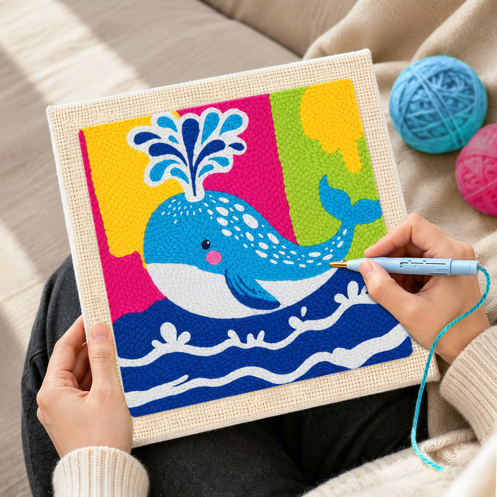 Creating handmade colorful spouting whale punch needle artwork