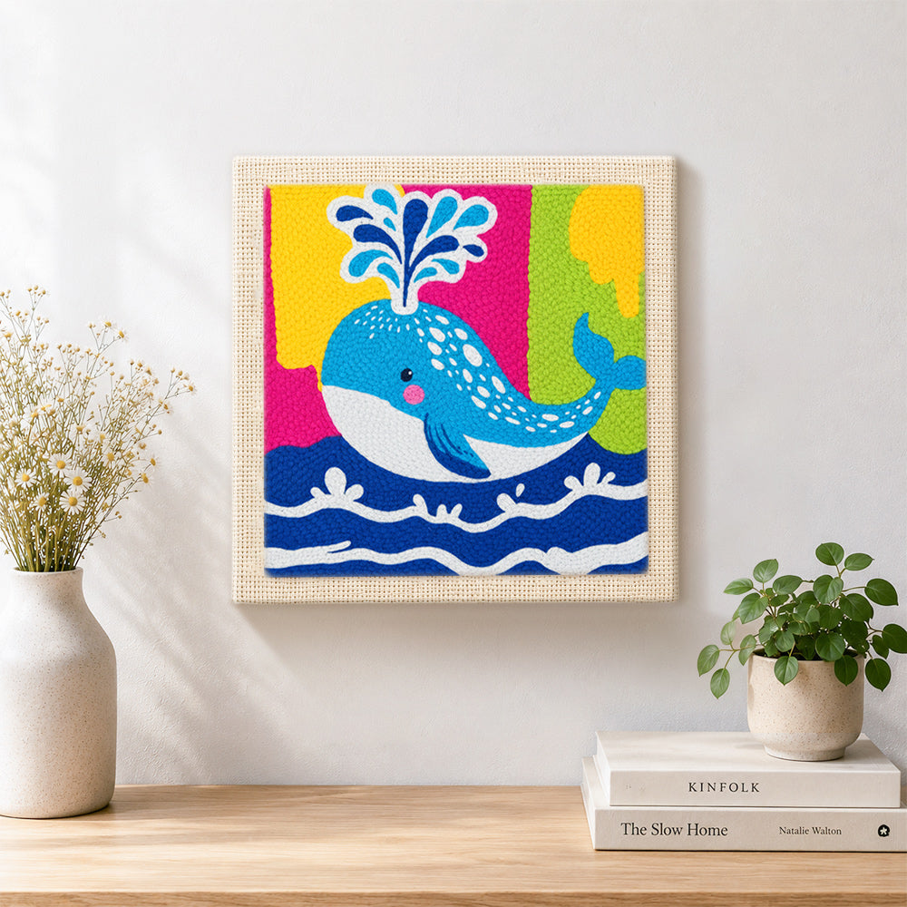 Finished colorful spouting whale artwork displayed on a wall