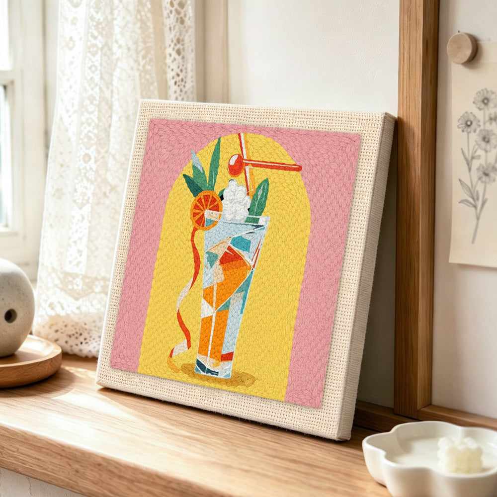Colorful tall cocktail punch needle artwork displayed on a table