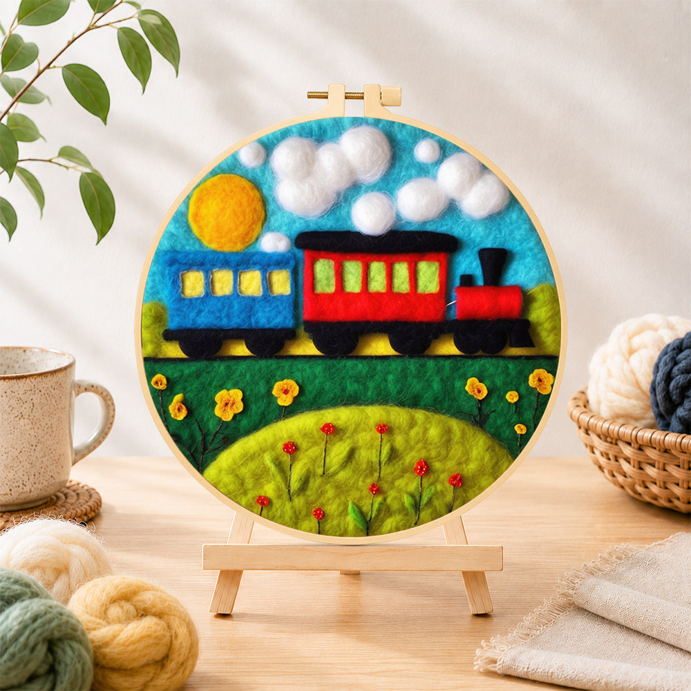 Finished colorful train on grass needle felting displayed on a wooden easel