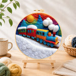 Finished colorful train on snowy hills needle felting displayed on a wooden easel
