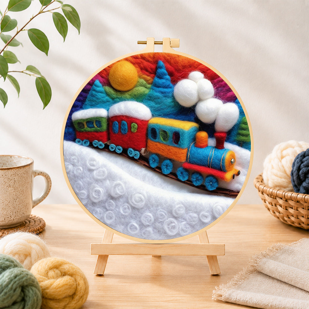 Finished colorful train on snowy hills needle felting displayed on a wooden easel