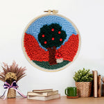 Finished colorful tree with red beads artwork displayed on a wall