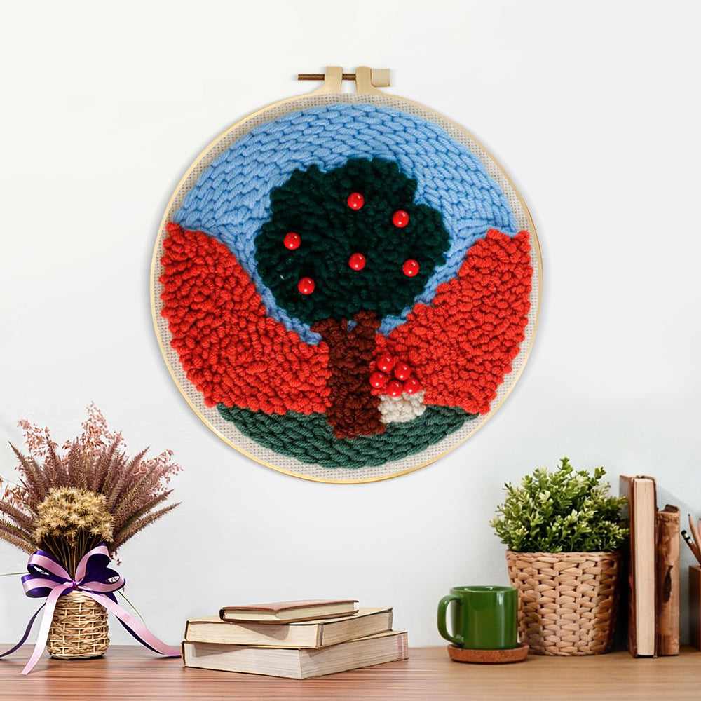 Finished colorful tree with red beads artwork displayed on a wall