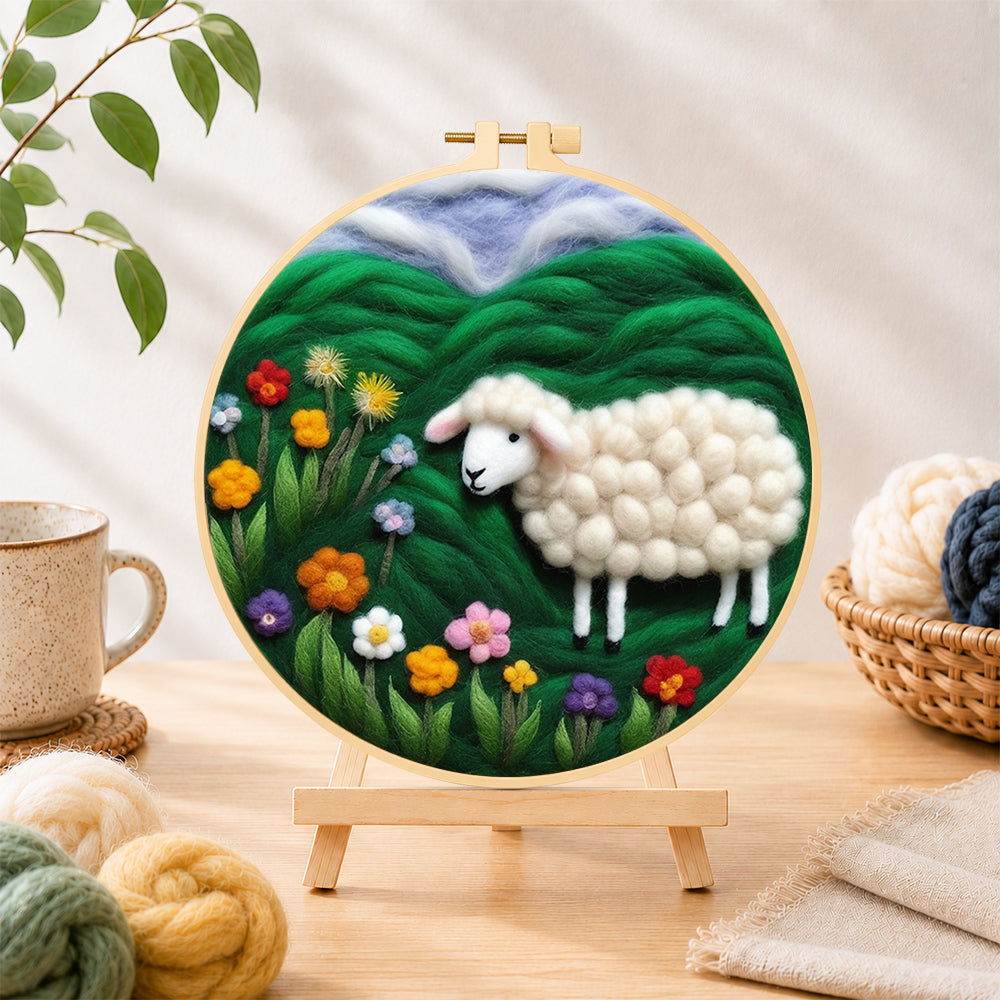 Finished colorful wildflower meadow with a sheep needle felting displayed on a wooden easel