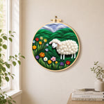 Colorful wildflower meadow with a sheep needle felt wall art displayed in a bright home interior