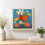 Finished colorful wildflowers artwork displayed on a wall