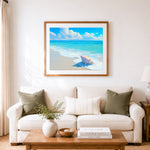 Finished conch shell by gentle waves cross stitch artwork displayed as home decor