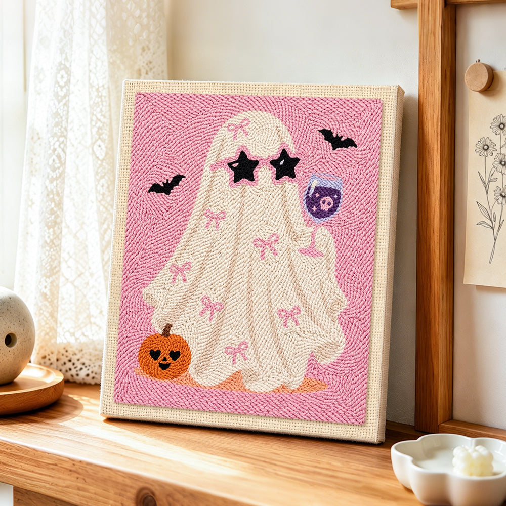 Coquette ghost with wine glass punch needle artwork displayed on a table