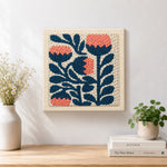 Finished coral and navy flowers artwork displayed on a wall
