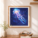 Finished cosmic glowing starry jellyfish cross stitch artwork displayed as home decor