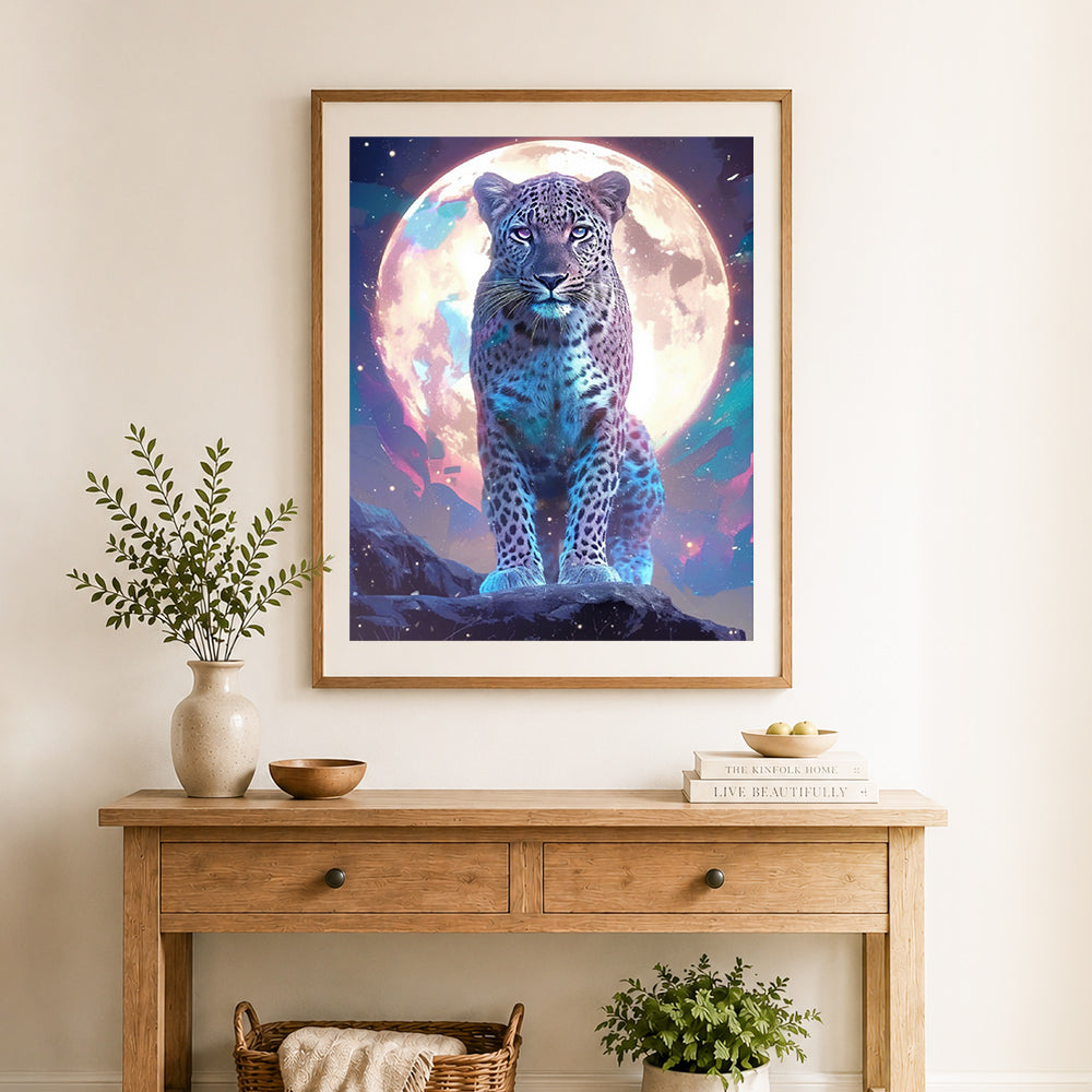 Finished cosmic moon leopard cross stitch artwork displayed as home decor