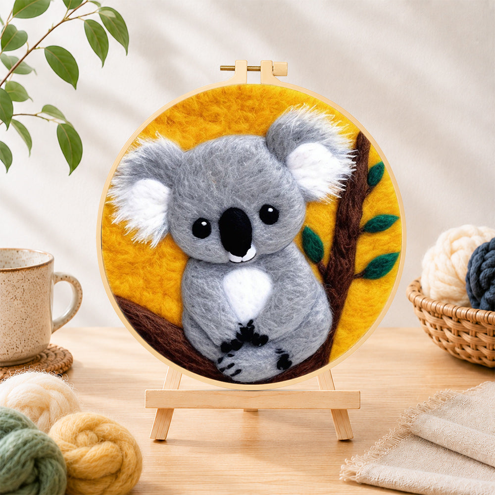 Finished cosy gray koala needle felting displayed on a wooden easel