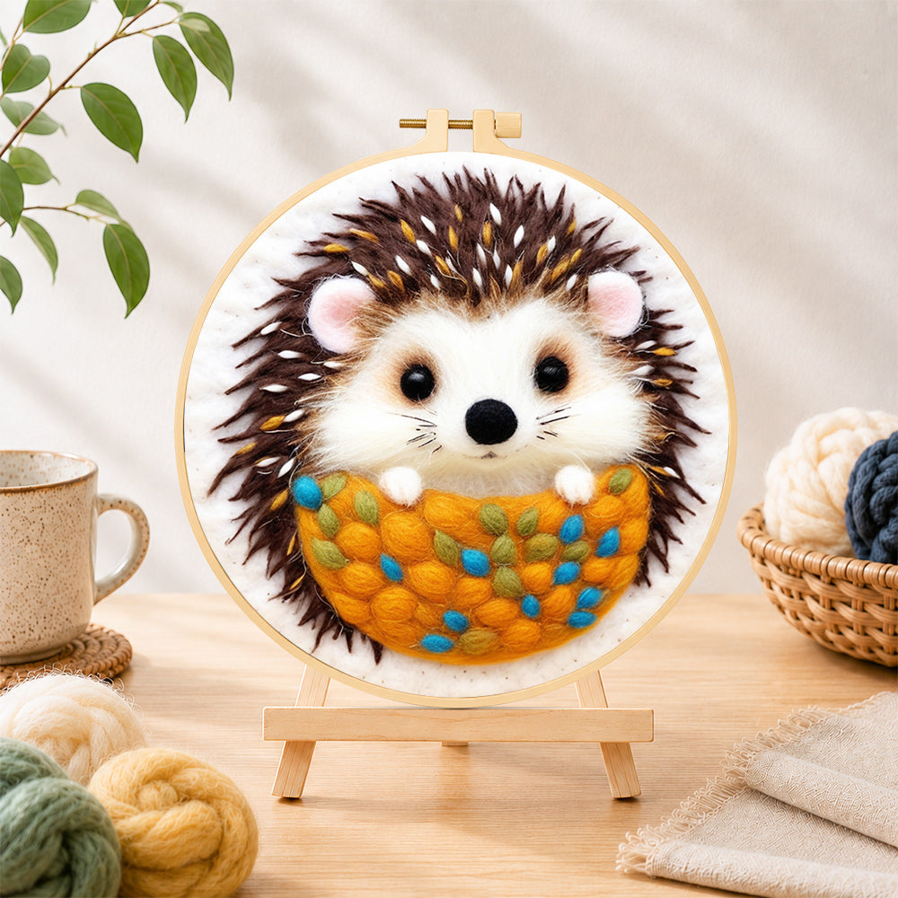 Finished cosy hedgehog needle felting displayed on a wooden easel