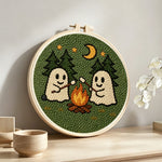 Cosy night camping ghosts punch needle artwork displayed on a table