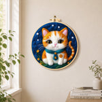 Cosy orange cat with teal bow tie needle felt wall art displayed in a bright home interior