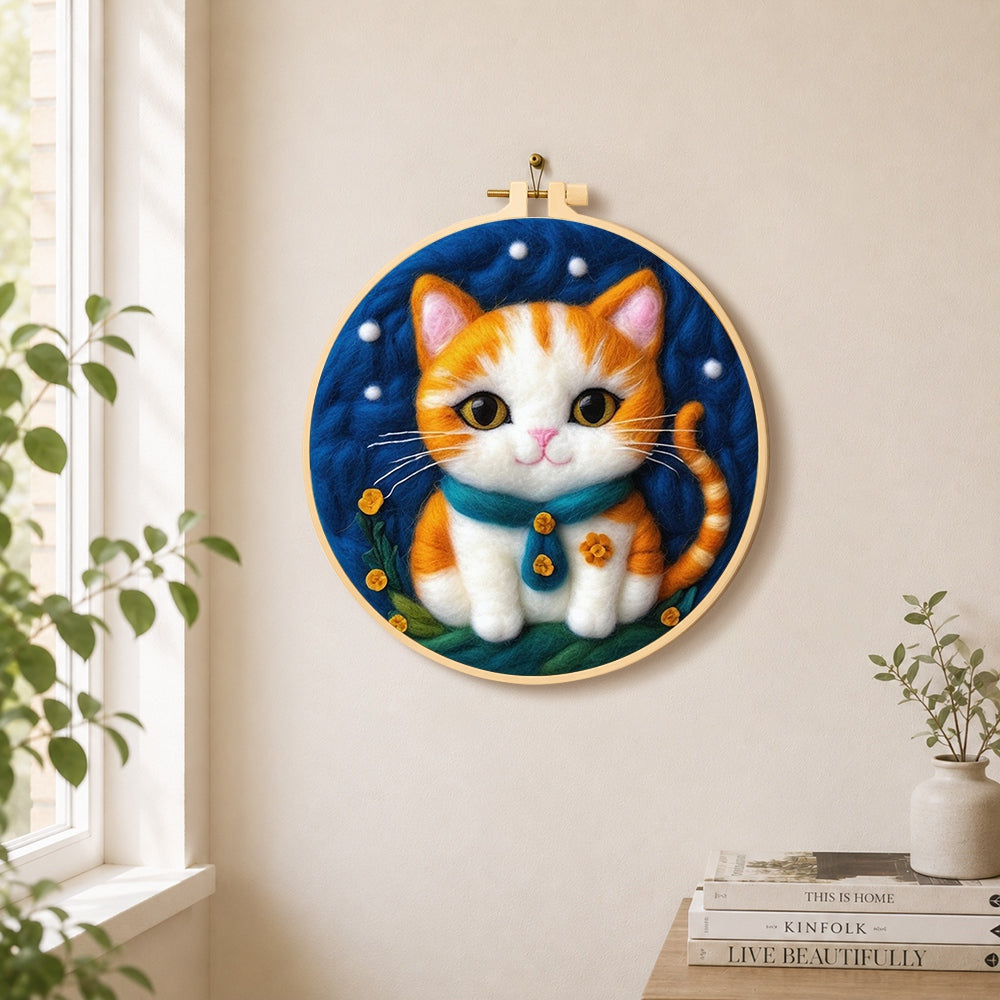 Cosy orange cat with teal bow tie needle felt wall art displayed in a bright home interior