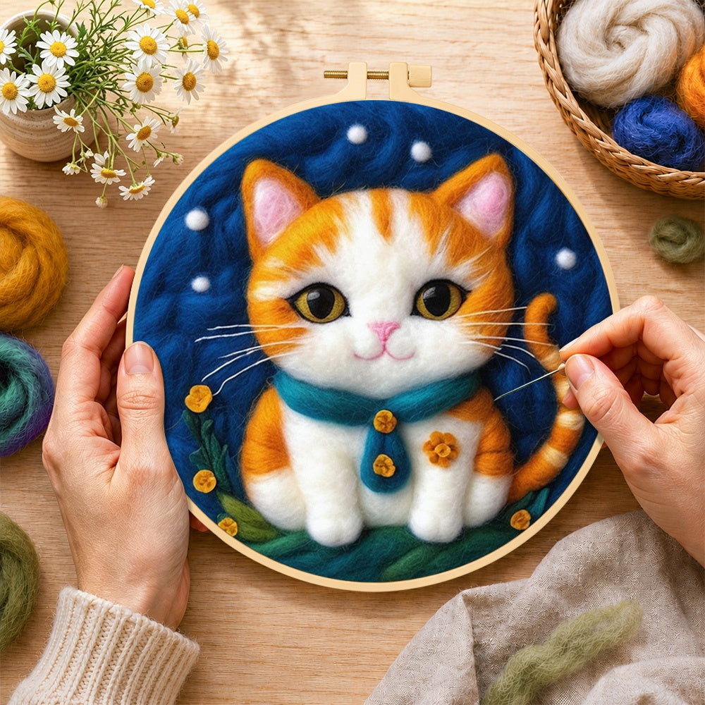 Creating the cosy orange cat with teal bow tie wool painting by hand with a felting needle