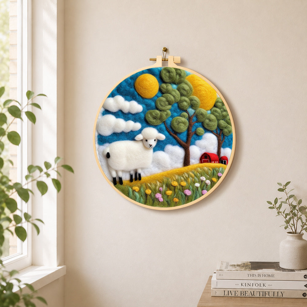 Cosy red barn farm scene with sheep needle felt wall art displayed in a bright home interior