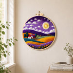 Cottage under the mystical purple night needle felt wall art displayed in a bright home interior