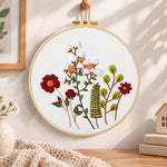 Cotton and burgundy flower arrangement embroidery hoop wall art displayed as warm and cozy handmade home decor