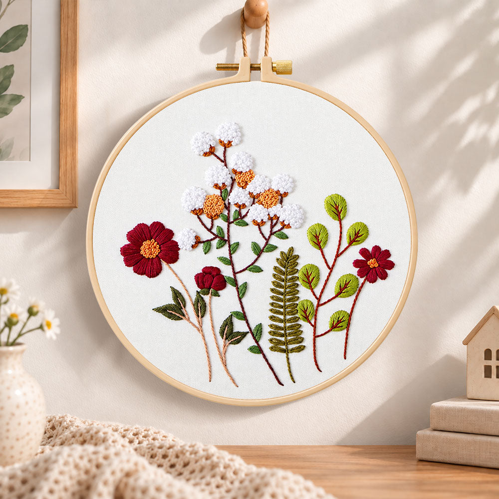 Cotton and burgundy flower arrangement embroidery hoop wall art displayed as warm and cozy handmade home decor