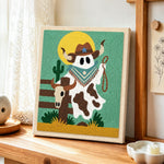 Cowboy ghost with lasso punch needle artwork displayed on a table