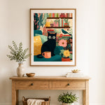 Finished cozy black cat with book and plants cross stitch artwork displayed as home decor