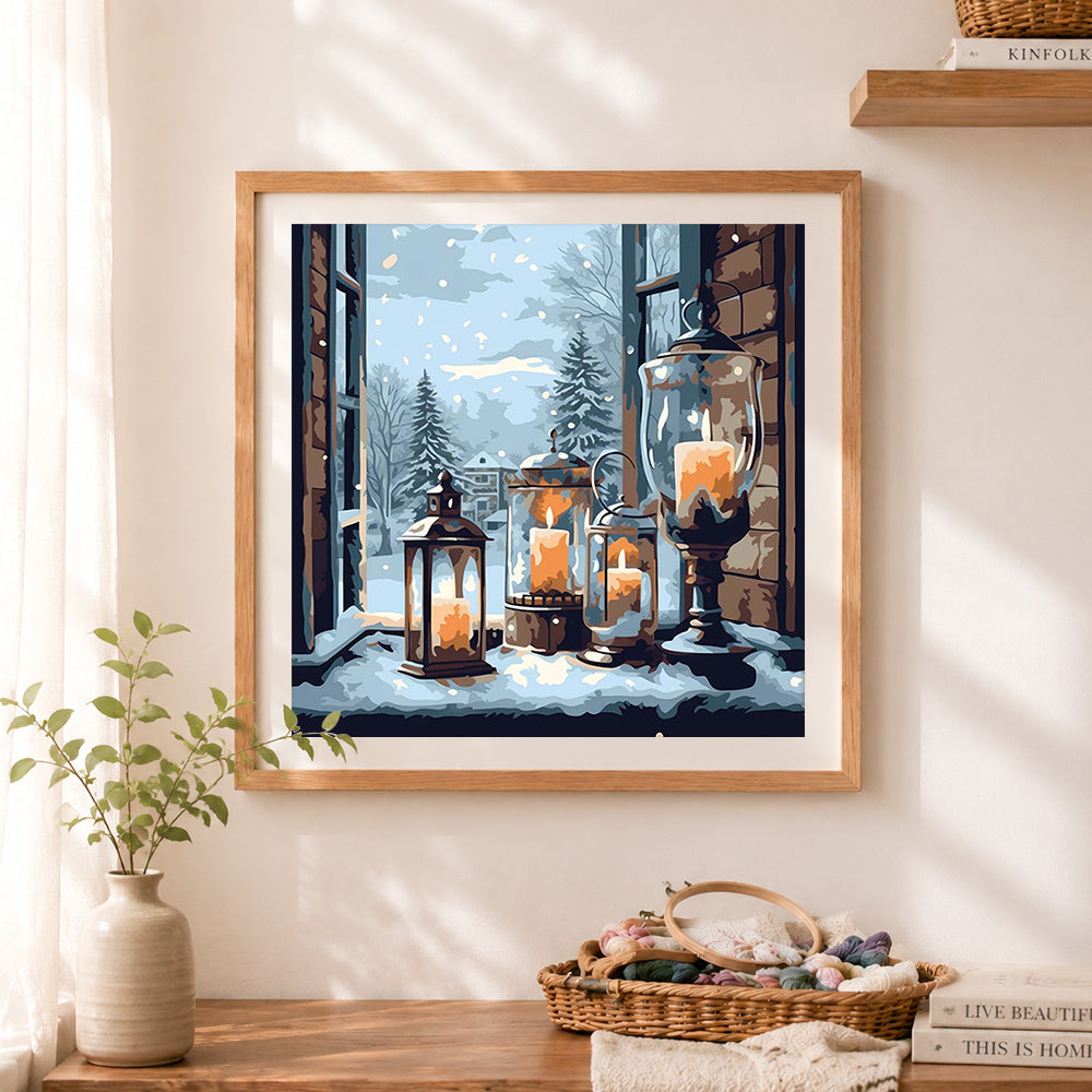 Finished cozy candles in snowy window cross stitch artwork displayed as home decor