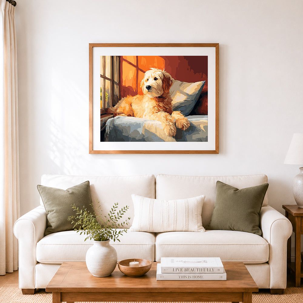 Finished cozy golden doodle on couch by window cross stitch artwork displayed as home decor