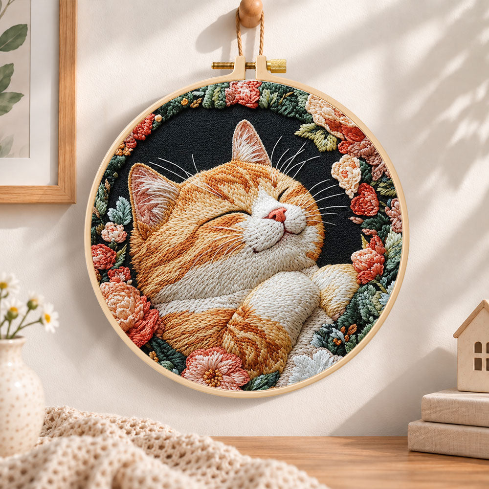 Cozy napping orange cat embroidery hoop wall art displayed as warm and cozy handmade home decor