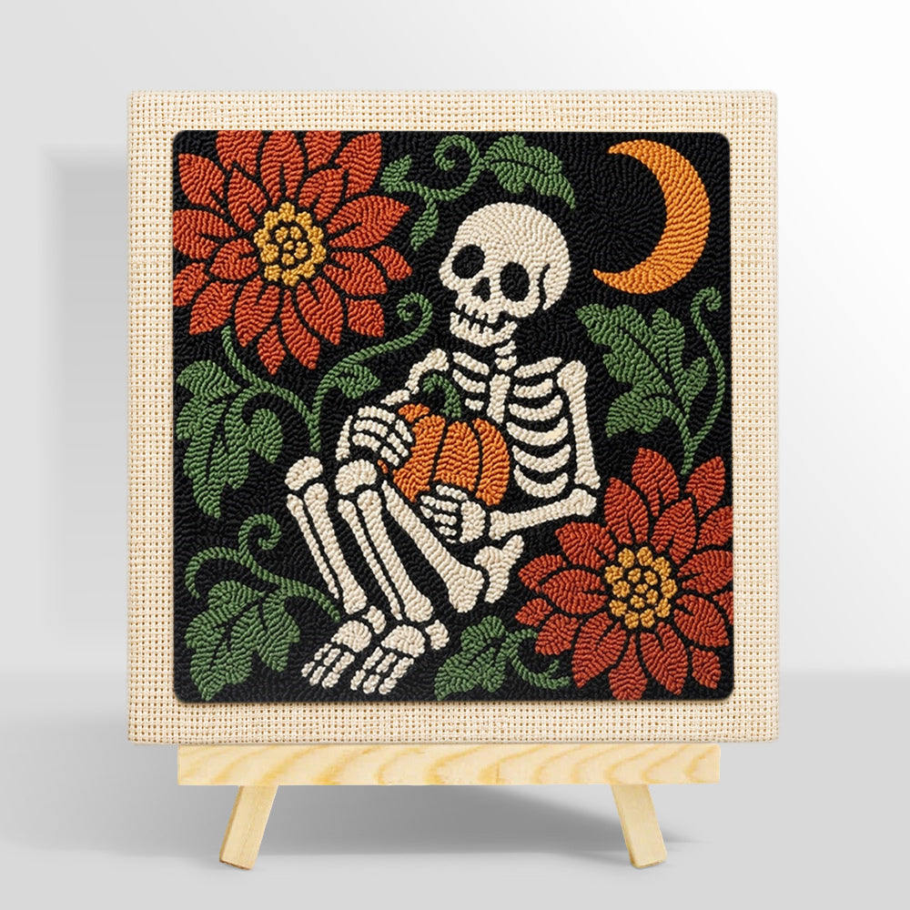 Cozy skeleton holding pumpkin punch needle kit for beginners
